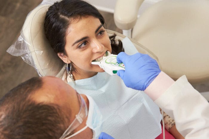 Dentist using Tekscan on patient